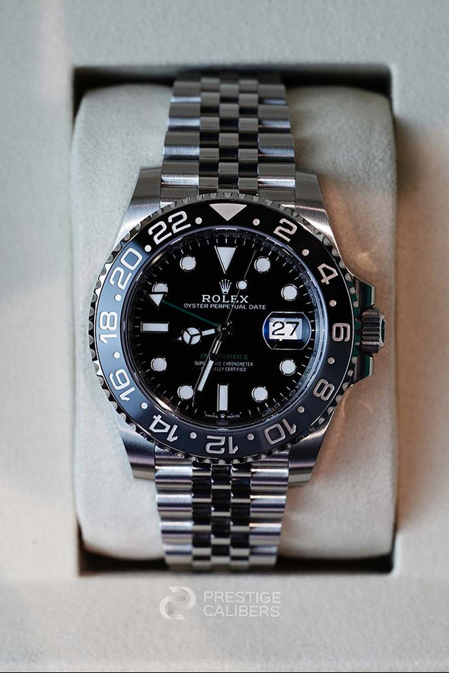 Rolex watch with black dial and silver metal bracelet in a box