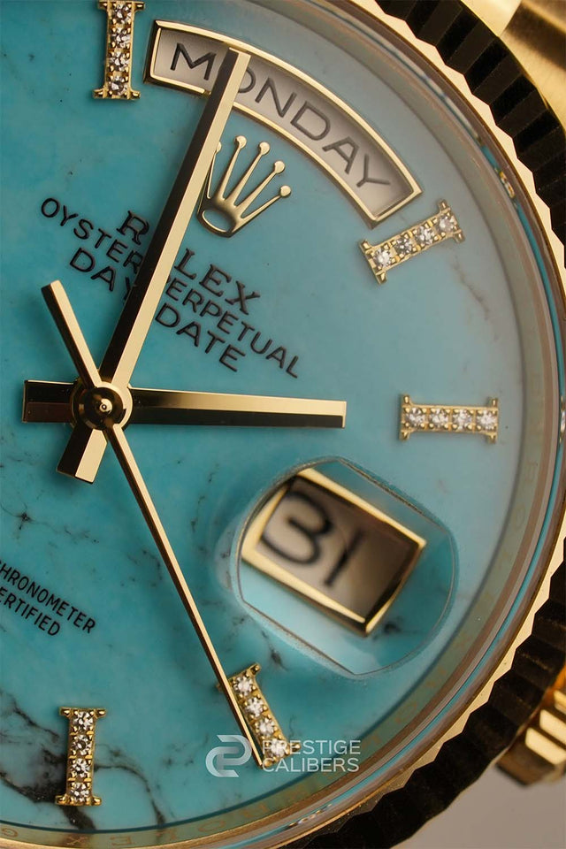 Close-up of a Rolex face with turquoise dial and gold accents. Rolex Oyster Perpetual Day-Date 36mm Turquoise Woman's watch 128238-0071
