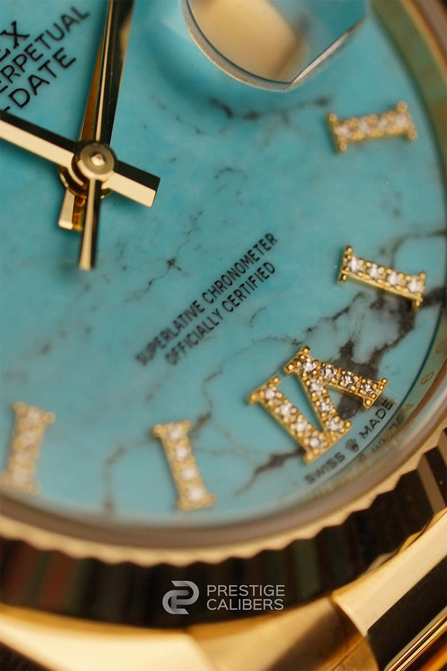 Close-up of a Rolex Oyster Perpetual Day-Date 36mm Turquoise Woman's watch 128238-0071 face with turquoise marbled design and gold Roman numerals incrusted with diamonds