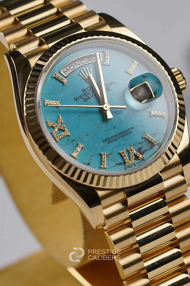 Yellow Gold Rolex Oyster Perpetual Day-Date 36mm Turquoise Woman's watch 128238-0071 with a blue face featuring Roman numerals