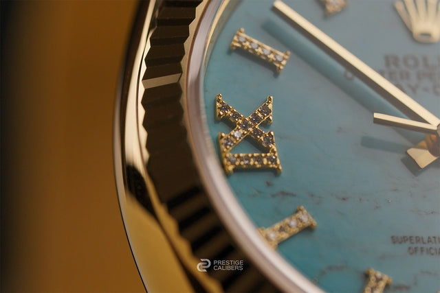 Close-up of a Rolex Oyster Perpetual Day-Date 36mm Turquoise Woman's watch 128238-0071 face with gold accents and blue dial, diamond roman numerals