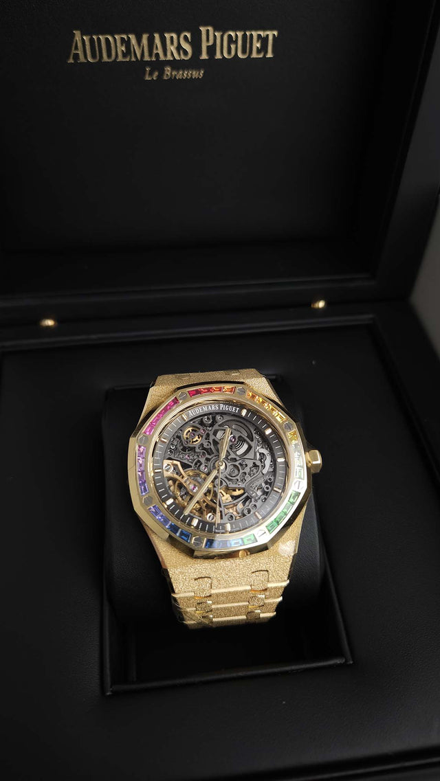 Audemars Piguet Royal Oak Frosted Gold Double Balance Wheel Openworked 15412BA.YG.1224BA.01 41 mm yellow gold men’s watch with rainbow gemstone bezel and openworked slate grey dial