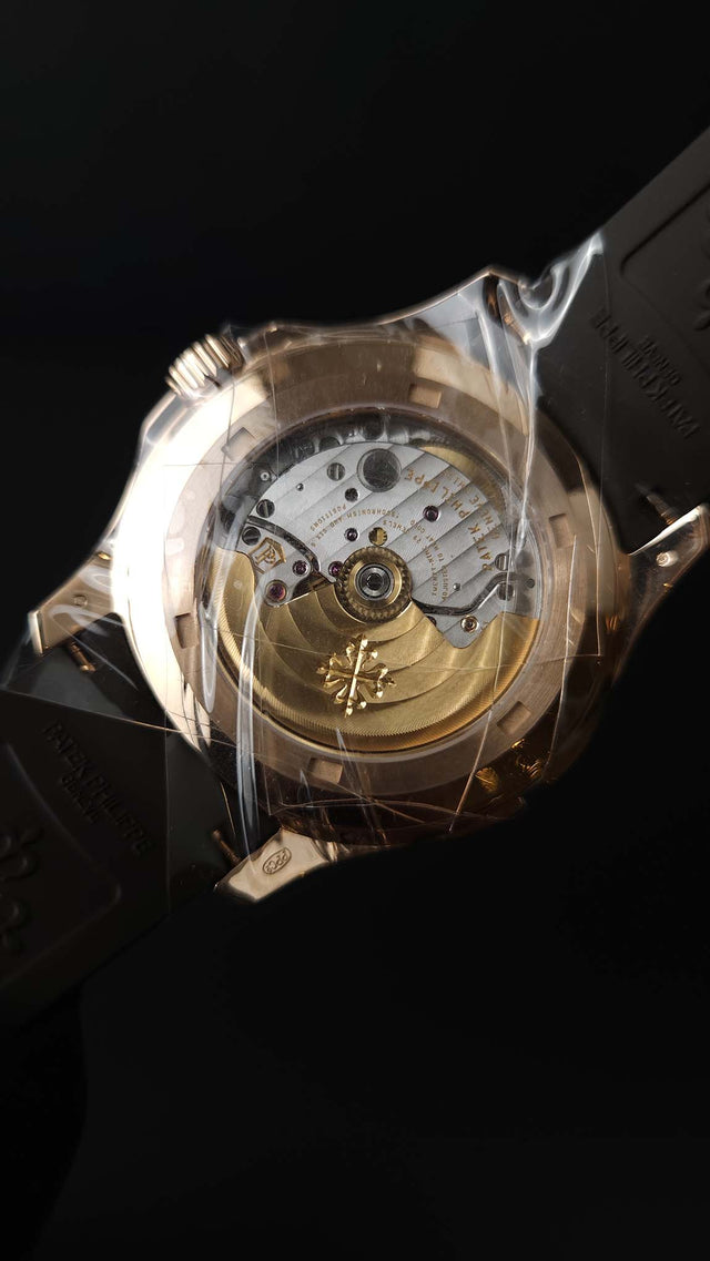 Patek Philippe Aquanaut Travel Time 5164R-001 40.8 mm rose-gold men’s watch with brown dial on brown rubber strap with folding clasp
