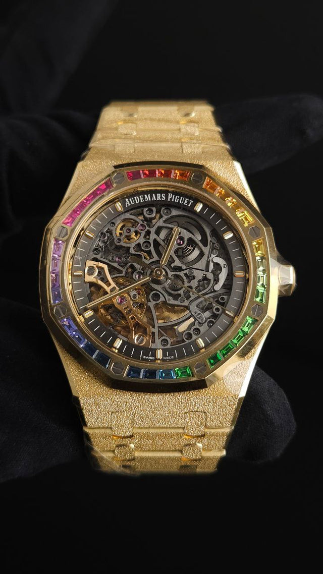 Audemars Piguet Royal Oak Frosted Gold Double Balance Wheel Openworked 15412BA.YG.1224BA.01 41 mm yellow gold men’s watch with rainbow gemstone bezel and openworked slate grey dial