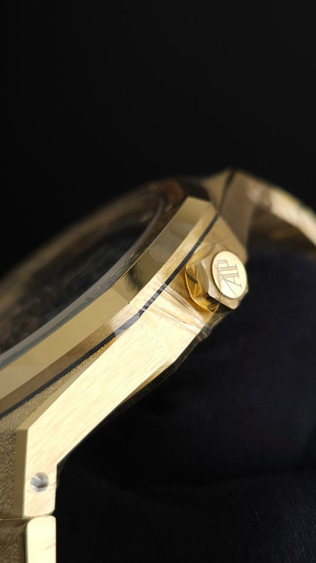 Audemars Piguet Royal Oak Frosted Gold Double Balance Wheel Openworked 15412BA.YG.1224BA.01 41 mm yellow gold men’s watch with rainbow gemstone bezel and openworked slate grey dial