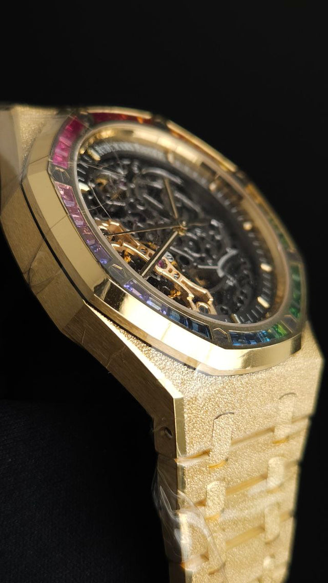 Audemars Piguet Royal Oak Frosted Gold Double Balance Wheel Openworked 15412BA.YG.1224BA.01 41 mm yellow gold men’s watch with rainbow gemstone bezel and openworked slate grey dial