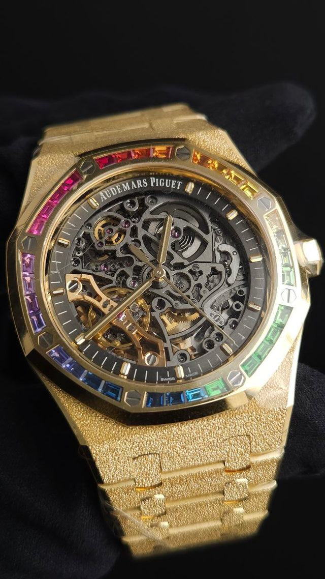Audemars Piguet Royal Oak Frosted Gold Double Balance Wheel Openworked 15412BA.YG.1224BA.01 41 mm yellow gold men’s watch with rainbow gemstone bezel and openworked slate grey dial