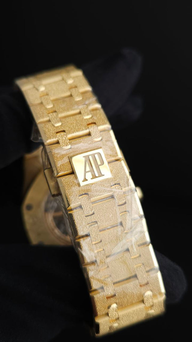Audemars Piguet Royal Oak Frosted Gold Double Balance Wheel Openworked 15412BA.YG.1224BA.01 41 mm yellow gold men’s watch with rainbow gemstone bezel and openworked slate grey dial